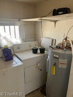 clothes washing area featuring independent washer and dryer and water heater