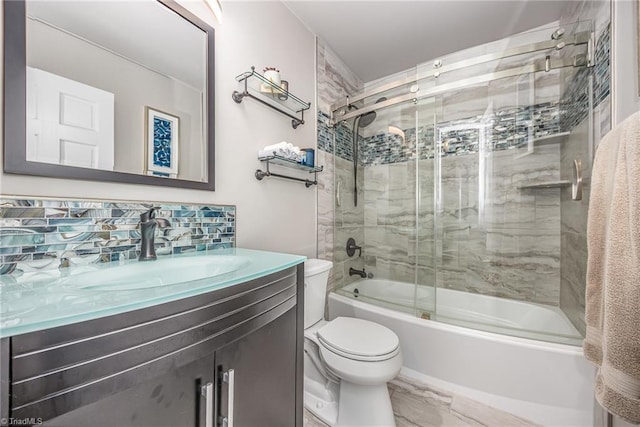 full bath featuring toilet, tasteful backsplash, shower / bath combination with glass door, and vanity