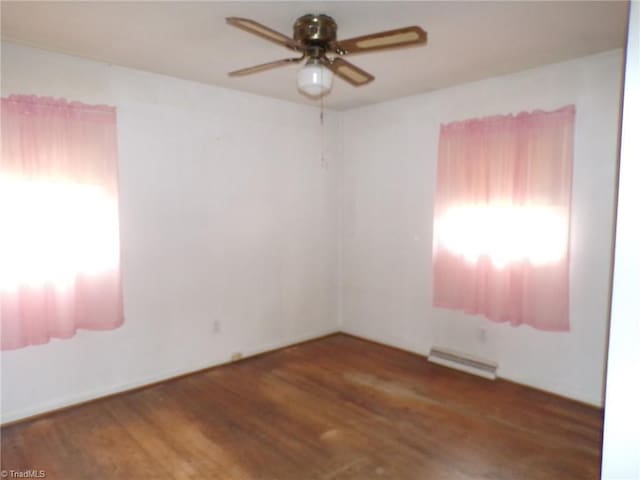 2600 Alamance Church Rd, Greensboro, NC 27406 - spare room featuring a ceiling fan, a baseboard heating unit, and wood finished floors