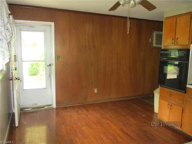 2600 Alamance Church Rd, Greensboro, NC 27406 - kitchen with oven, wood finished floors, a ceiling fan, healthy amount of natural light, and wood walls
