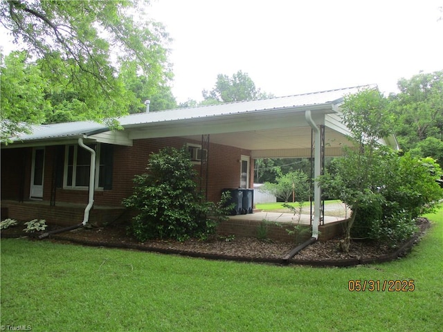 2600 Alamance Church Rd, Greensboro, NC 27406 - view of home's exterior with a yard, a carport, brick siding, and a metal roof