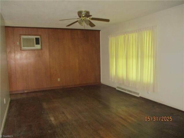 2600 Alamance Church Rd, Greensboro, NC 27406 - unfurnished room featuring a ceiling fan, dark wood-style flooring, an AC wall unit, and wooden walls
