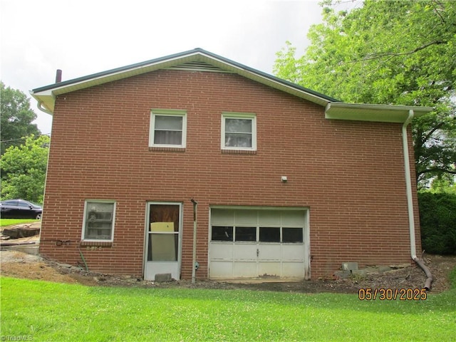 2600 Alamance Church Rd, Greensboro, NC 27406 - back of house featuring brick siding, a garage, and a lawn