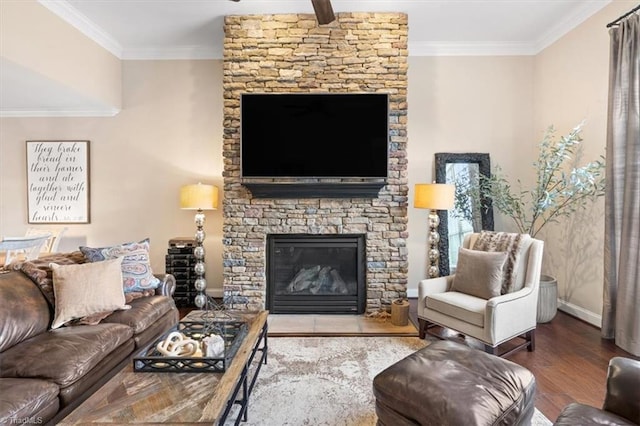 living room featuring hardwood / wood-style flooring, a stone fireplace, and ornamental molding