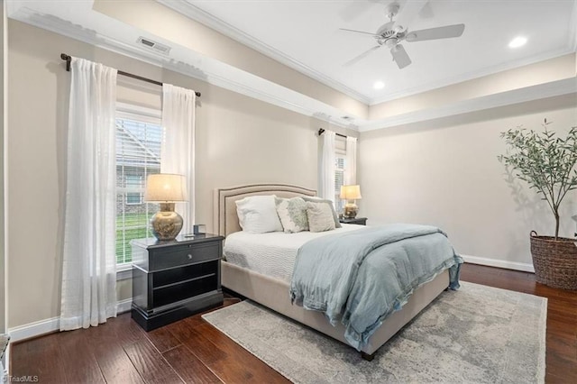 bedroom with crown molding, ceiling fan, and dark wood-type flooring