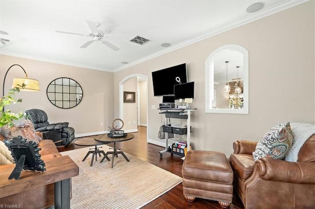 living room featuring crown molding, ceiling fan, and dark wood-type flooring