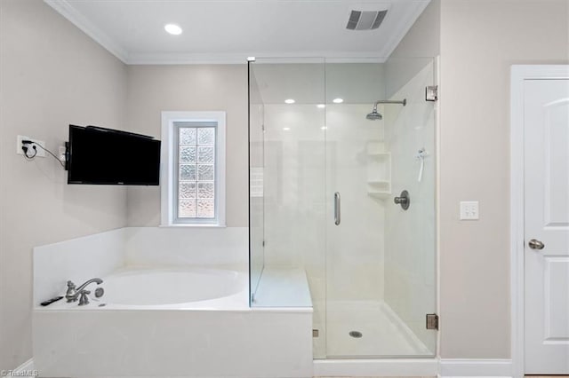 bathroom featuring ornamental molding and shower with separate bathtub