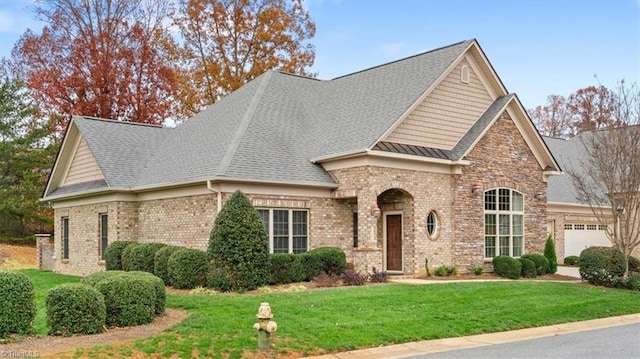 view of front of house with a garage and a front lawn