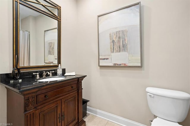 bathroom with tile patterned floors, vanity, and toilet