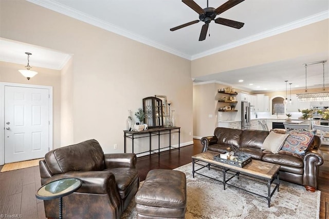 living room with hardwood / wood-style floors, ceiling fan, and crown molding