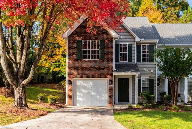 view of front of property featuring a garage and a front lawn