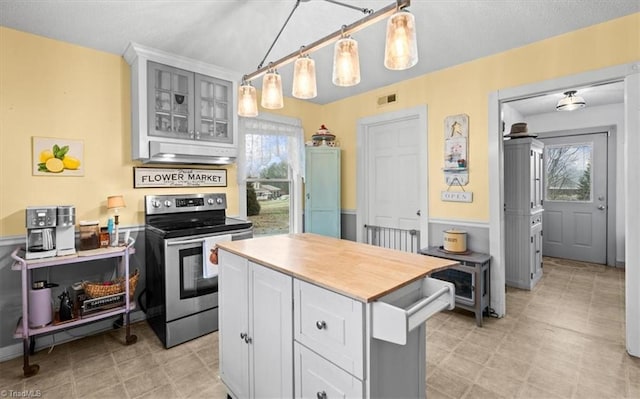 kitchen with gray cabinetry, stainless steel range with electric cooktop, and decorative light fixtures