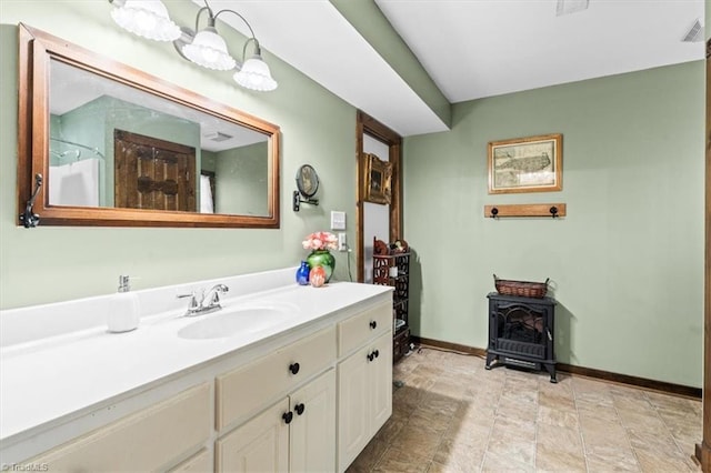 bathroom featuring vanity, a shower, and a wood stove