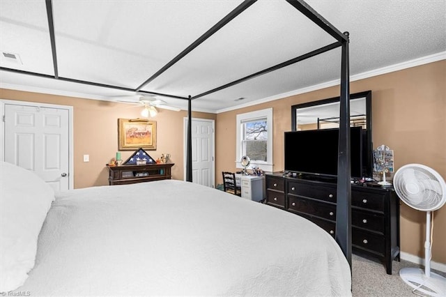 bedroom with ornamental molding, carpet, and ceiling fan