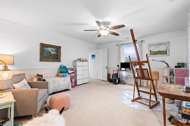 carpeted office with crown molding, ceiling fan, and a textured ceiling