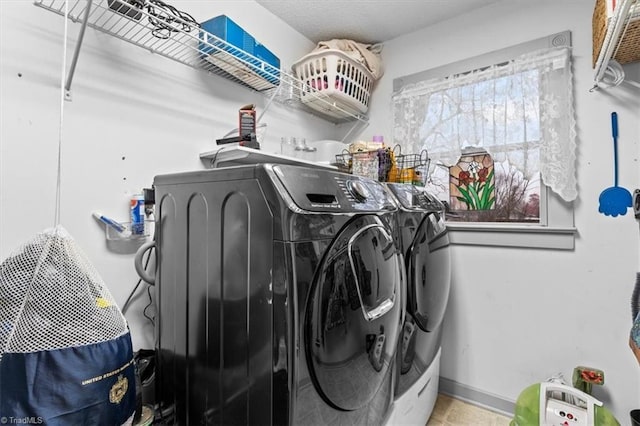 laundry area featuring tile patterned floors and washer and dryer