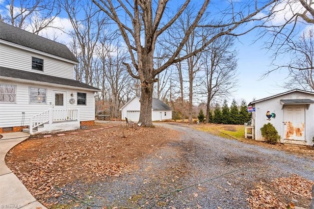 view of property exterior featuring a garage and an outbuilding