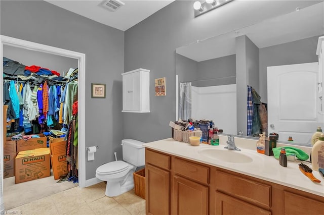 4455 Brassfield Dr Unit 306, Winston-Salem, NC 27105 - bathroom with vanity, toilet, curtained shower, a spacious closet, and tile patterned floors