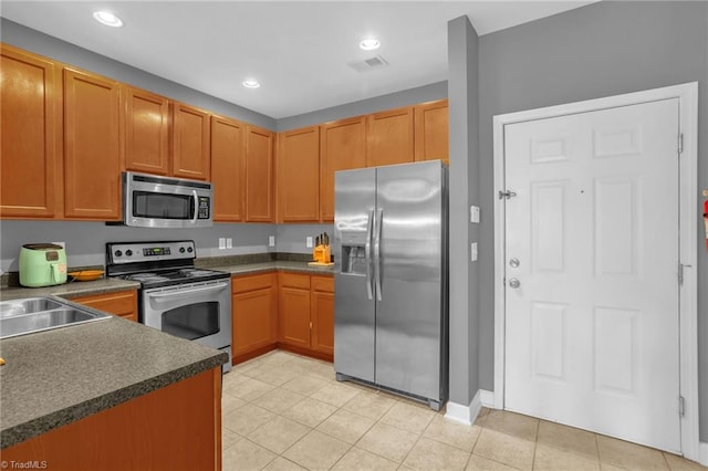 4455 Brassfield Dr Unit 306, Winston-Salem, NC 27105 - kitchen with appliances with stainless steel finishes, dark countertops, light tile patterned flooring, recessed lighting, and a sink