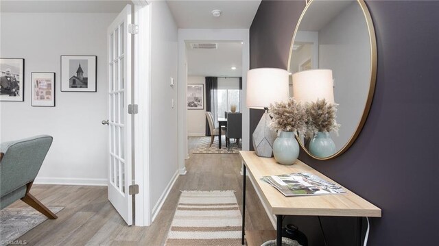 hallway with hardwood / wood-style flooring