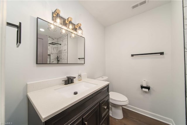 full bath with vanity, baseboards, visible vents, walk in shower, and toilet