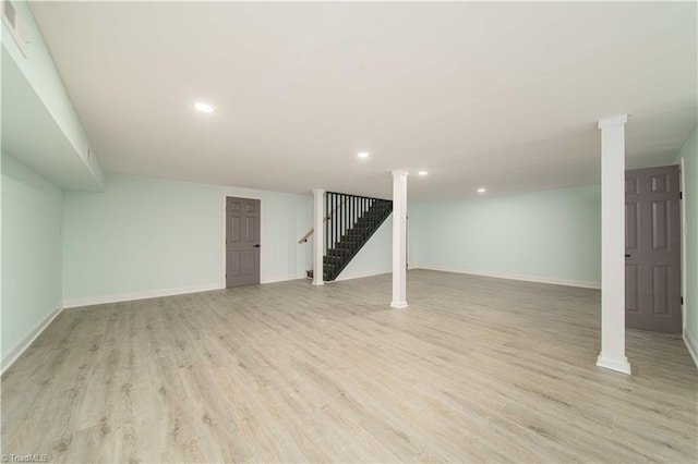 finished below grade area with stairs, recessed lighting, baseboards, and light wood-type flooring