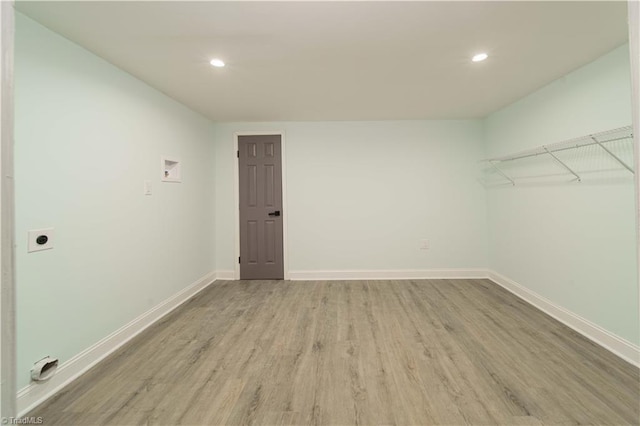 empty room featuring recessed lighting, baseboards, and wood finished floors