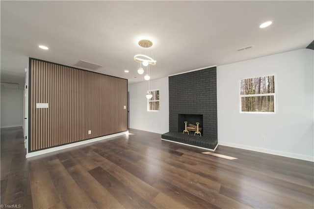 unfurnished living room featuring recessed lighting, visible vents, wood finished floors, and a fireplace