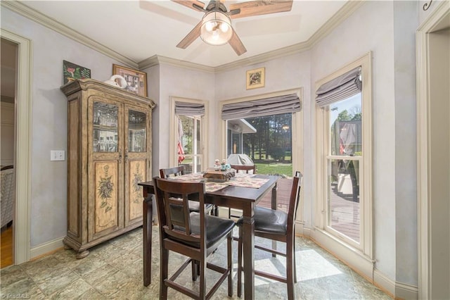 dining space with baseboards, a ceiling fan, and crown molding