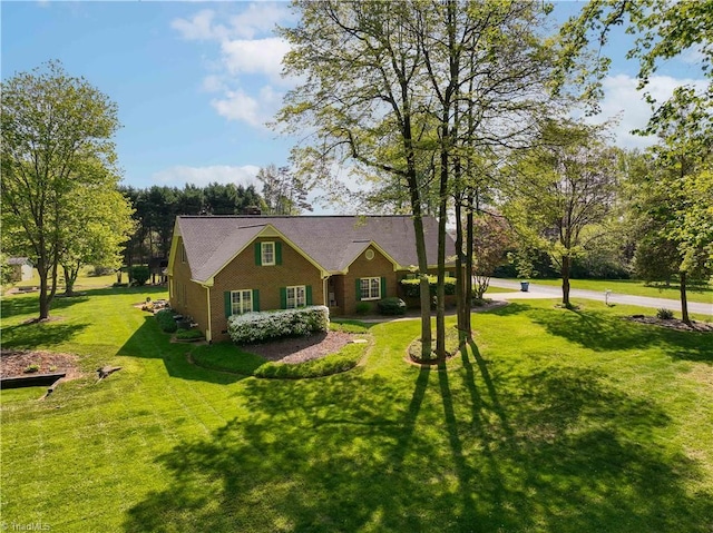 view of front of home featuring a front lawn and brick siding
