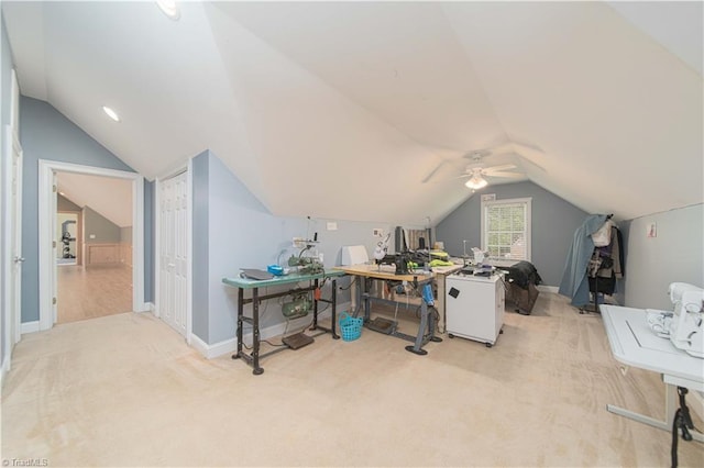 carpeted home office with vaulted ceiling, a ceiling fan, and baseboards