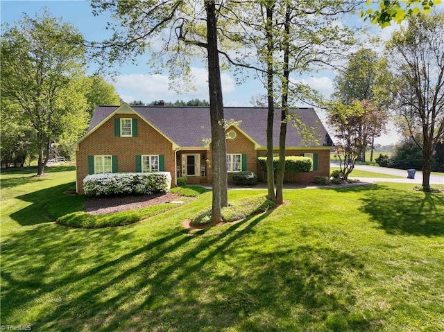 view of front facade featuring a front lawn and brick siding