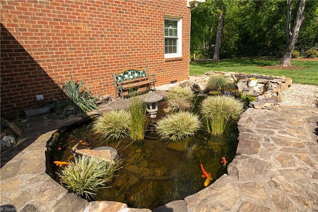 view of yard featuring a small pond