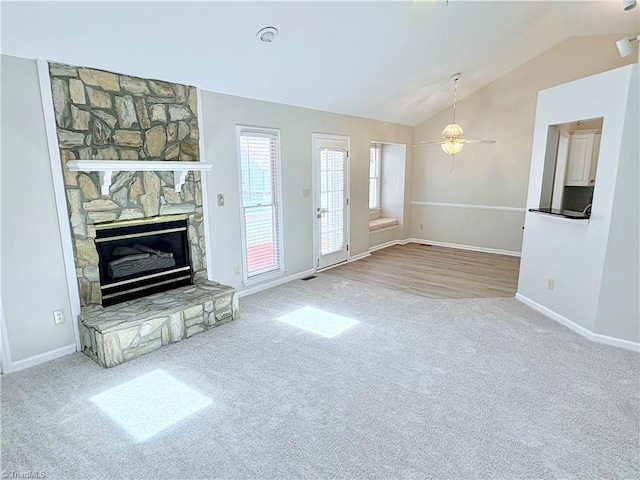 204 Maplewood Ct, Trinity, NC 27370 - unfurnished living room featuring carpet, lofted ceiling, a stone fireplace, and ceiling fan