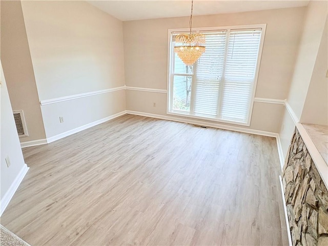 204 Maplewood Ct, Trinity, NC 27370 - empty room with a chandelier and wood finished floors