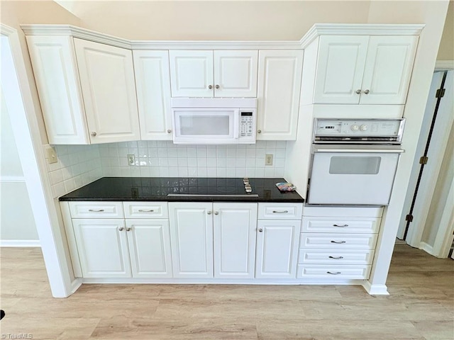 204 Maplewood Ct, Trinity, NC 27370 - kitchen with white appliances, light wood-style flooring, white cabinetry, and dark countertops