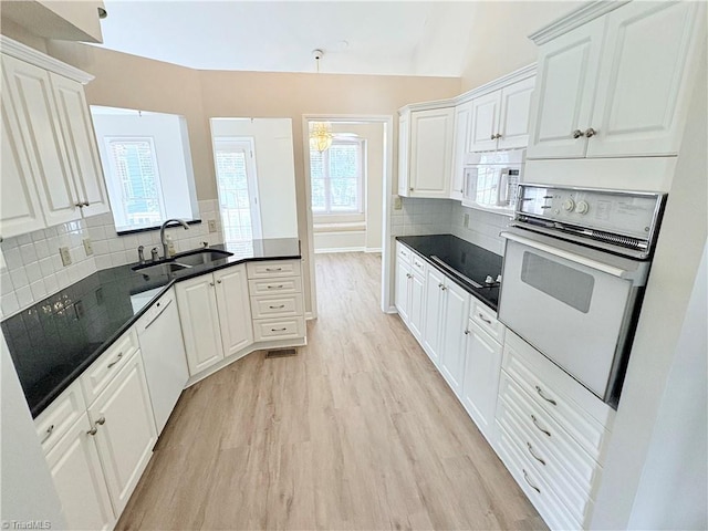 204 Maplewood Ct, Trinity, NC 27370 - kitchen with white appliances, light wood-style flooring, white cabinetry, tasteful backsplash, and a peninsula