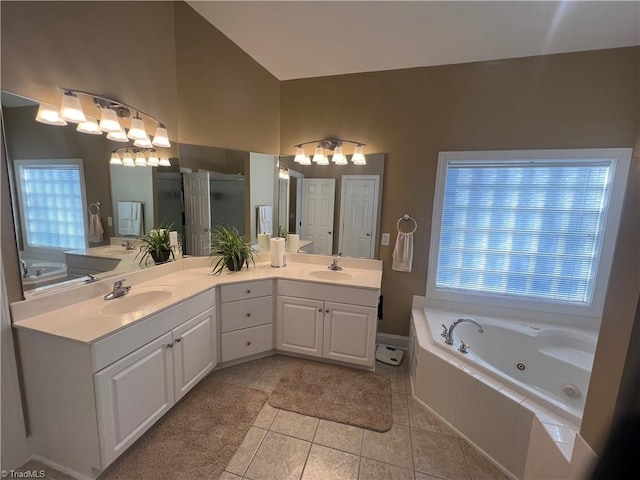 bathroom featuring tile patterned flooring, separate shower and tub, and vanity