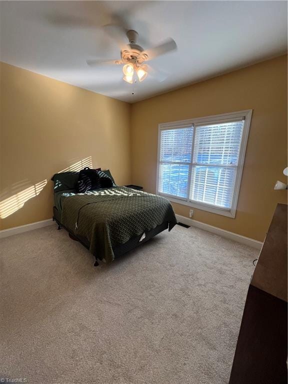 bedroom with ceiling fan and light colored carpet