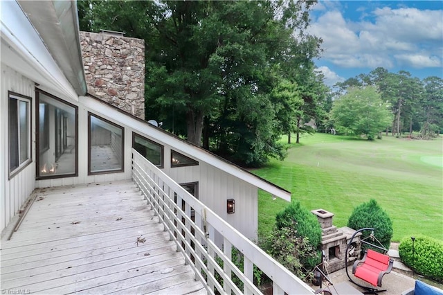 wooden deck featuring a yard and view of golf course