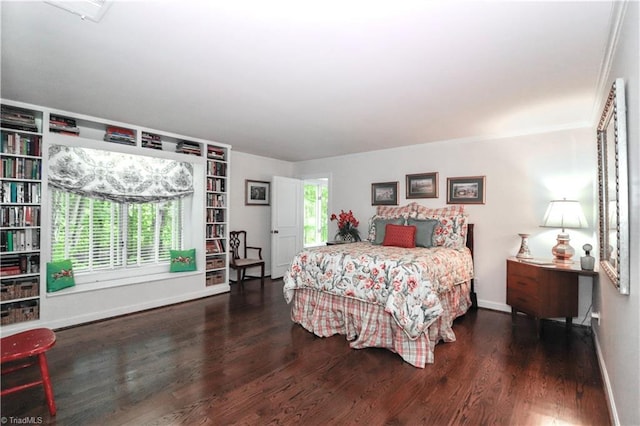 bedroom with dark wood finished floors and baseboards