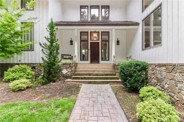 doorway to property featuring stone siding