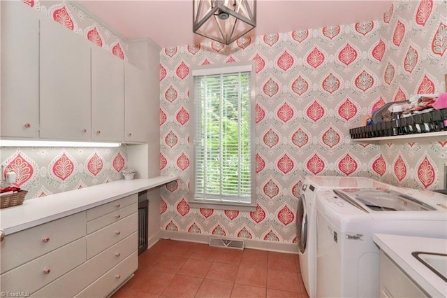 washroom with washing machine and clothes dryer, cabinet space, a healthy amount of sunlight, baseboards, and wallpapered walls