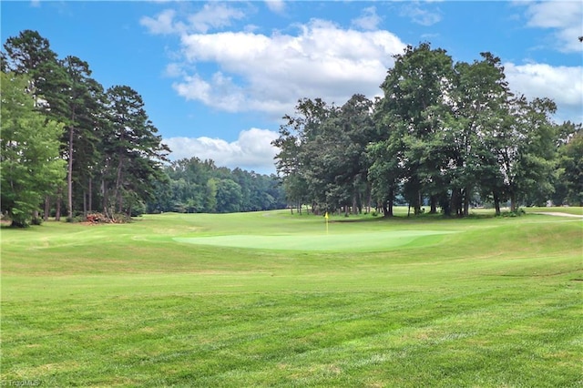 view of community featuring a yard and golf course view