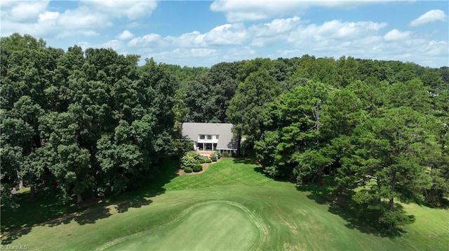 aerial view featuring golf course view and a view of trees