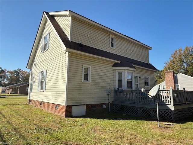 back of house featuring a deck, a yard, and crawl space