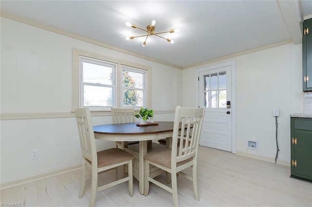 dining area featuring light wood-style floors and baseboards