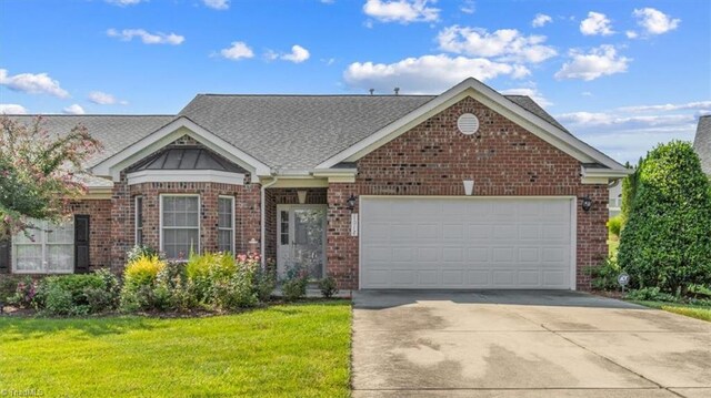 view of front of property with a garage and a front lawn