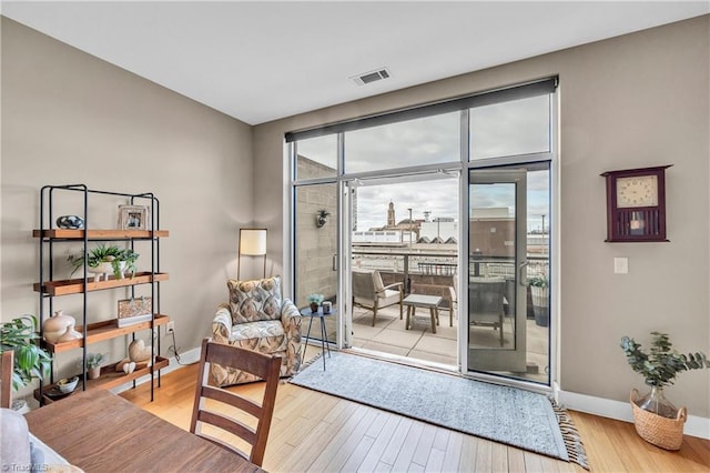 entryway featuring wood finished floors, visible vents, and baseboards