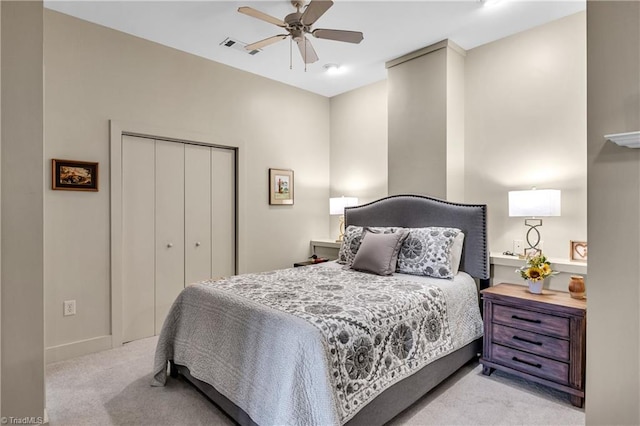 bedroom featuring visible vents, baseboards, a ceiling fan, a closet, and carpet